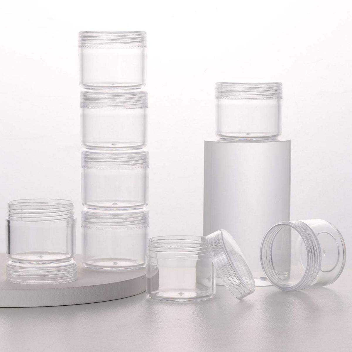 Refillable Cosmetic Sample Jars - 100 Pack 20g (0.7oz) Clear Small Travel Containers with Lids + 10 Mini Makeup Spatulas - BPA Free